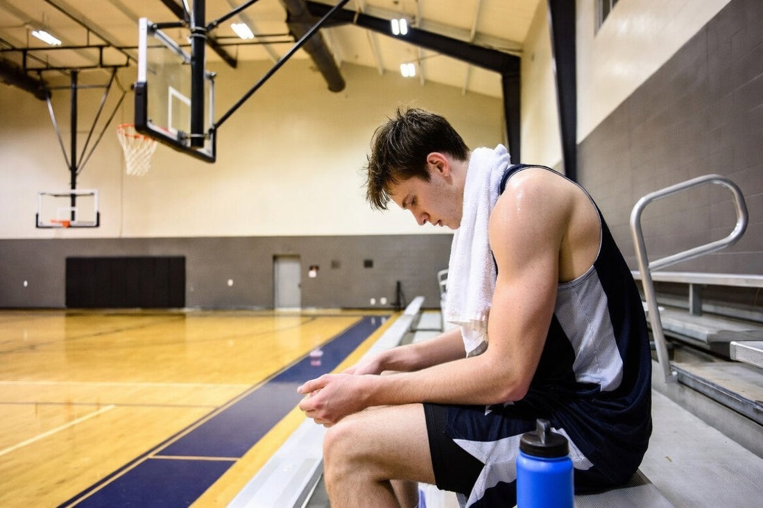 basketball player resting after training and losing electrolytes through sweat